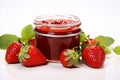 Sweet strawberry jam in a glass jar on white background with copy space for text placement Royalty Free Stock Photo