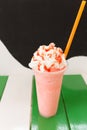 Sweet strawberry milkshake and frappe - iced and milk blended wi