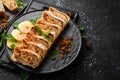 Sweet Strudel with apples and dried fruits. Top view, free copy space