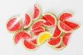 Sweet sugar marmalade in the form of slices of watermelon and lime lies on the white surface of the store counter