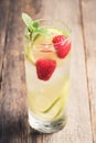 Sweet summer cocktail with raspberry and lime on the rustic background Royalty Free Stock Photo
