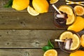 Summer iced tea, top view corner border on a dark wood background