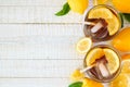 Summer iced tea, top view side border on a white wood background