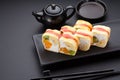 Sweet sushi roll in mamenori on a stone plate. Royalty Free Stock Photo