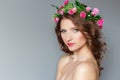 Sweet sweet beautiful young girl with a wreath of flowers on her head, with bare shoulders with beauty makeup soft pink lips Royalty Free Stock Photo