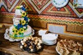 Sweet table. A plates of cakes and muffins with cream with berries. Table with sweets, candy, buffet. Dessert table for a party Royalty Free Stock Photo