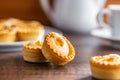 Sweet tarlets. Tasty mini tarts. Mini pie with cream on kitchen table