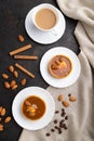 Sweet tartlets with almonds and caramel cream with cup of coffee on a black concrete background. flat lay, close up Royalty Free Stock Photo