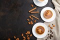 Sweet tartlets with almonds and caramel cream with cup of coffee on a black concrete background. flat lay, copy space Royalty Free Stock Photo