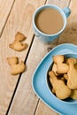 Sweet tasty cookies in the blue plate, a cup of coffee with milk Royalty Free Stock Photo