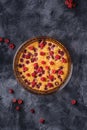 Sweet tasty pie with jellied and fresh raspberry fruits in baking dish, dark stone concrete background Royalty Free Stock Photo