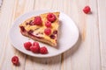 Sweet tasty pie slice with jellied and fresh raspberry fruits in plate, wooden table background Royalty Free Stock Photo