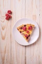 Sweet tasty pie slice with jellied and fresh raspberry fruits in plate, wooden table background Royalty Free Stock Photo