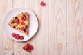 Sweet tasty pie slice with jellied and fresh raspberry fruits in plate, wooden table background Royalty Free Stock Photo