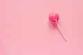 Sweet tasty pink lollipop on pink background. Minimal flat lay with copy space Royalty Free Stock Photo