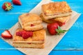 Sweet tasty puff pastry dessert on wooden background.