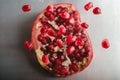 Sweet tasty sour pomegranate seeds flying over peeled fruit