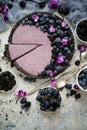 Sweet and tasty tart with fresh blueberries, blackberries and grapes, served on stone background Royalty Free Stock Photo