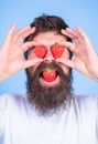 Sweet temptation. Berries sweet happiness. Man in love with strawberry. Hipster with beard eats strawberry and hold Royalty Free Stock Photo