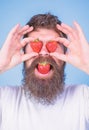 Sweet temptation. Berries sweet happiness. Man in love with strawberry. Hipster with beard eats strawberry and hold Royalty Free Stock Photo