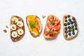 Sweet toast assortment with fresh fruit and berries on white. Royalty Free Stock Photo