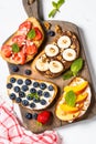 Sweet toast assortment with fresh fruit and berries on white. Royalty Free Stock Photo