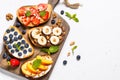 Sweet toast assortment with fresh fruit and berries on white. Royalty Free Stock Photo