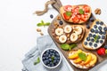 Sweet toast assortment with fresh fruit and berries on white. Royalty Free Stock Photo