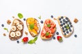 Sweet toast assortment with fresh fruit and berries on white. Royalty Free Stock Photo