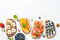 Sweet toast assortment with fresh fruit and berries on white. Royalty Free Stock Photo