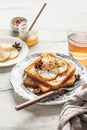 Sweet toast with cream cheese, caramelized pear, nuts and honey with cup of tea for breakfast on textured background Royalty Free Stock Photo