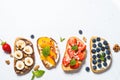 Sweet toast assortment with fresh fruit and berries on white. Royalty Free Stock Photo