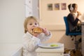 Sweet toddler child, boy, eating hot dog at home Royalty Free Stock Photo