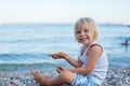 Sweet toddler child, eating pizza on the beach, having fun, smiling happily, kid enjoying dinner Royalty Free Stock Photo