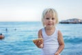Sweet toddler child, eating pizza on the beach, having fun, smiling happily, kid enjoying dinner Royalty Free Stock Photo