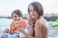 Sweet toddler child, eating pizza on the beach, having fun, smiling happily, kid enjoying dinner Royalty Free Stock Photo