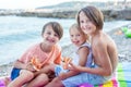 Sweet toddler child, eating pizza on the beach, having fun, smiling happily, kid enjoying dinner Royalty Free Stock Photo