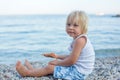 Sweet toddler child, eating pizza on the beach, having fun, smiling happily, kid enjoying dinner Royalty Free Stock Photo