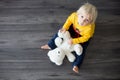 Sweet toddler child, playing doctor, examining teddy bear toy Royalty Free Stock Photo