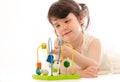 Sweet toddler girl concentrated playing with educational baby to