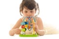Sweet toddler girl concentrated playing with educational baby wo