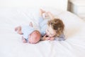 Sweet toddler girl supporting her newborn brother Royalty Free Stock Photo