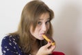 Sweet tooth girl eating eclairs Royalty Free Stock Photo