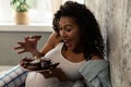 Happy pregnant woman crowing eating chocolate cookies. Royalty Free Stock Photo