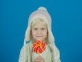 A sweet tooth. Little girl hold lollipop on stick. Little child with sweet lollipop. Happy candy girl. Happy childhood