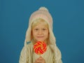 A sweet tooth. Little girl hold lollipop on stick. Little child with sweet lollipop. Happy candy girl. Happy childhood