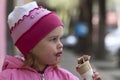 A sweet-toothed young girl with ice-cream and with smeary face