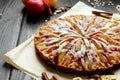 Sweet traditional homemade german apple pie cake with nuts and cinnamon on dark wooden table