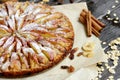 Sweet traditional homemade german apple pie cake with nuts and cinnamon on dark wooden table Royalty Free Stock Photo
