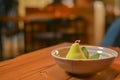 Sweet unique dessert. White chocolate pear served in a bowl in restaurant.